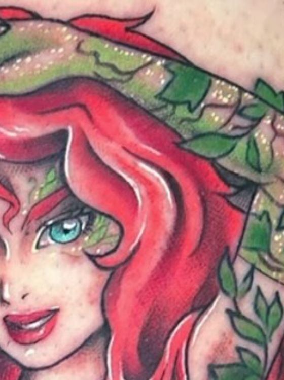 Color portrait tattoo of a red-haired woman among ivy