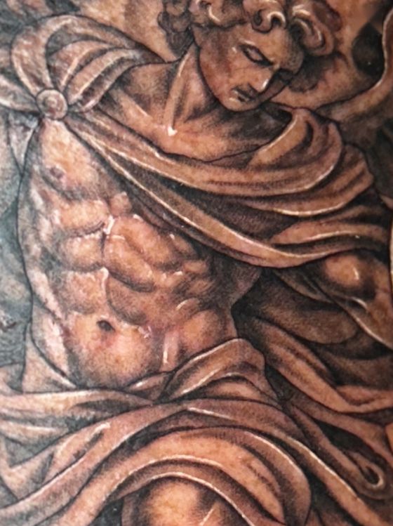 Realistic classical statue of a robed figure tattoo
